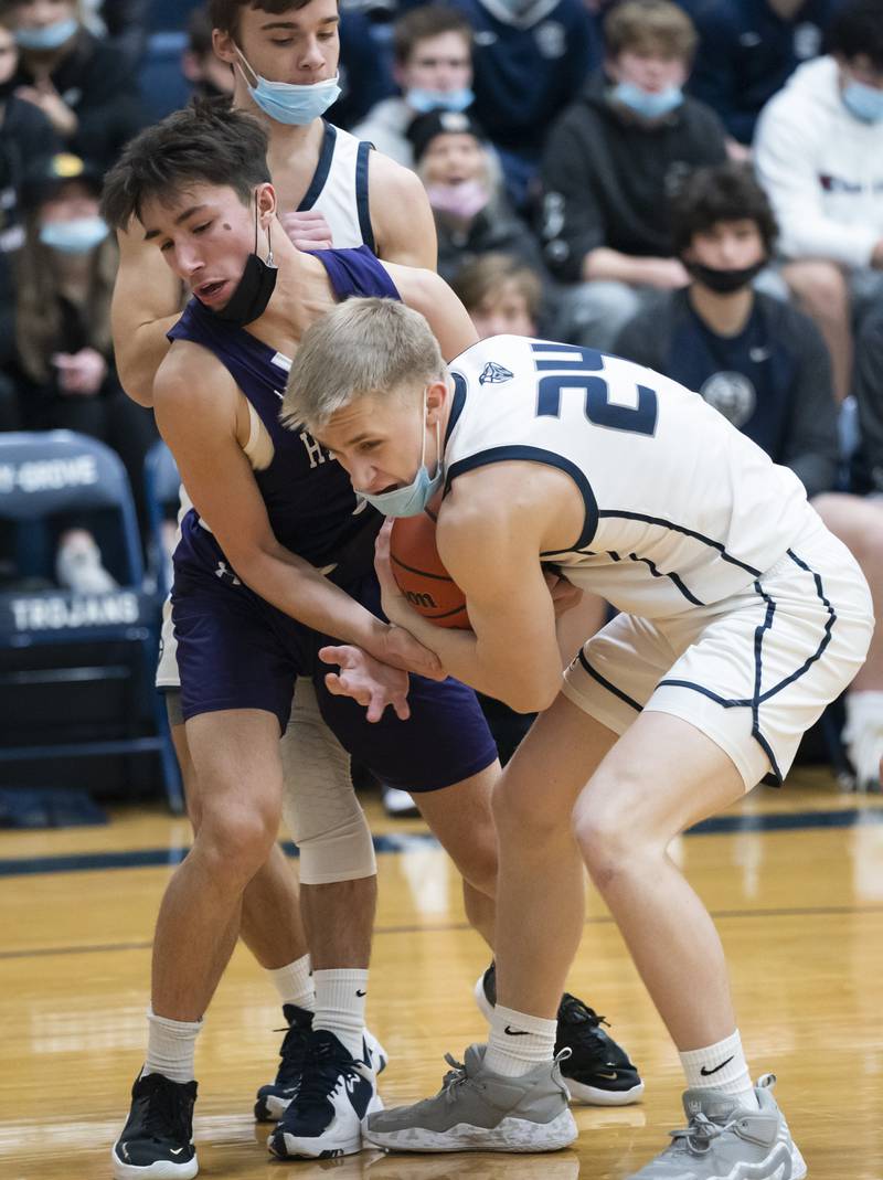Cary-Grove's Ryan Zielinski battles for a rebound with Hampshire's Tristan Villareal during their game on Tuesday, January 25, 2022 at Cary-Grove High School in Cary.