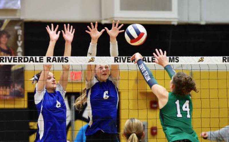 Princeton's Keighley Davis and Caroline Keutzer team up for a block against Peoria Notre Dame in Tuesday's sectional semifinals at Riverdale.