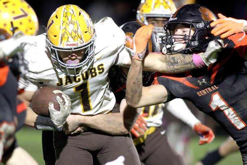 Crystal Lake Central’s Drake Tomasiewicz, right, reaches to try and snag Jacobs’ Joey Scrivani, left, in varsity football at Metcalf Field on the campus of Crystal Lake Central Friday night.