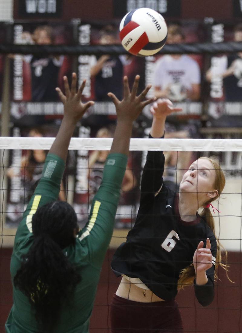 Prairie Ridge's Sonora Bekere hits the ball agains the block of Crystal Lake South's Sahara Okirika during the IHSA Class 3A Prairie Ridge Regional championship volleyball match on Thursday, Oct. 30, 2025, at the Prairie Ridge High School in Crystal Lake.