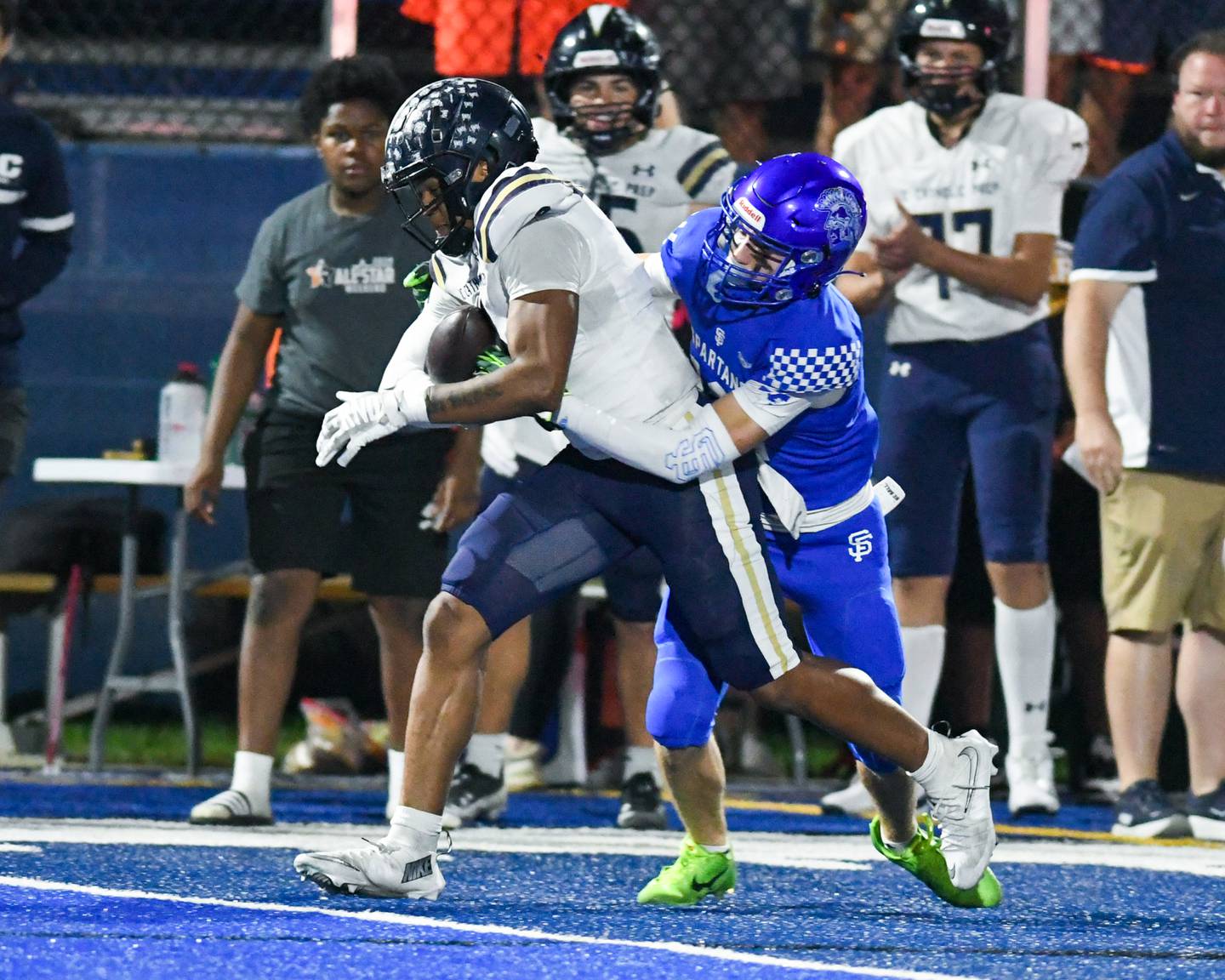 IC Catholic Prep's Tamarion Garner (8) escapes the arms of St. Francis's Dario Milivojevic (12) during the game on Friday Oct. 3, 2025, that turned into a touchdown held at St. Francis High School.