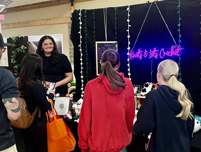 Rock Falls High School junior Arianna Reyna greets customers at her business, Knots & Lots Crochet, in Sterling's Northland Mall at the Whiteside Area Career Center's CEO program student trade show on April 23, 2025.