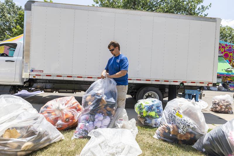 Brian Douchet of Dixon prepares prizes Tuesday, July 1, 2025, for Wednesday’s opening of the Petunia Fest carnival. The fest kicks off with crafts with the Petunia royalty Wednesday at the library.