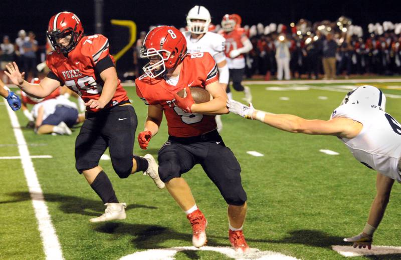 Yorkville running back Ryan Wulff (8) breaks a New Trier tackle during a varsity football game at Yorkville High School on Friday, Sep. 1, 2023.