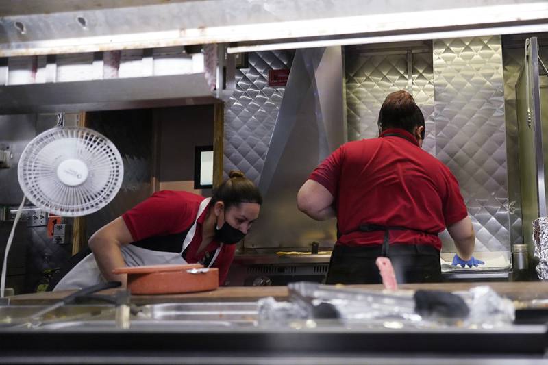 File - Women work in a restaurant kitchen in Chicago, Thursday, March 23, 2023. On Friday, the U.S. government issues the May jobs report. The labor market has added jobs at a steady clip in the past year, despite efforts by the Federal Reserve to cool the economy and bring down inflation.