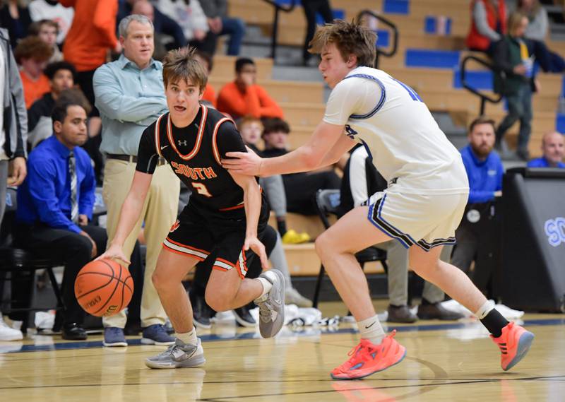 Wheaton Warrenville South Christian Triscik (3) moves around St. Charles North's Daniel Connolly (10) during a game on Friday, December 2, 2022.