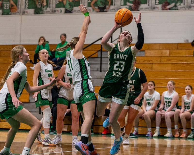 St. Bede's Lili McClain (23) lays ball up as Olivia Buck (11) of Dwight jumps in attempt to contest shot on Monday, January 19, 2026 at the Krese Memorial Gymnasium in Dwight.