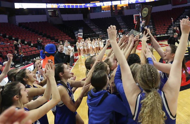 Members of the Geneva girls basketball team hoist the Class 4A third place trophy after defeating Geneva during the third place game on Friday, March 3, 2023 at CEFCU Arena in Normal.