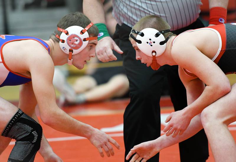 Oregon's Seth Stevens (left) and Woodstock Marian's Charlie Fitzgerald start their 138-pound match at the 1A Oregon Wrestling Sectional on Friday night.