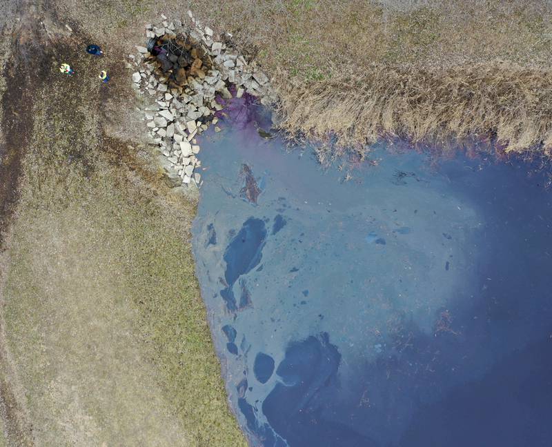 Environmental officials look at a holding pond where a chemical agent spilled into it just to the east of Carus Chemical next to the Little Vermilion River on Thursday, Jan. 12, 2023 in La Salle.