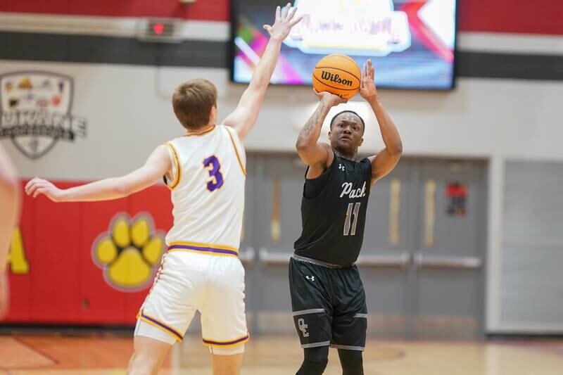Oswego East's Reginald McWaine (11) shoots a three pointer against Downers Grove North's Nolan Hurter (3) during a Batavia Night of Hoops Basketball game at Batavia High School on Saturday, Jan. 25, 2025.