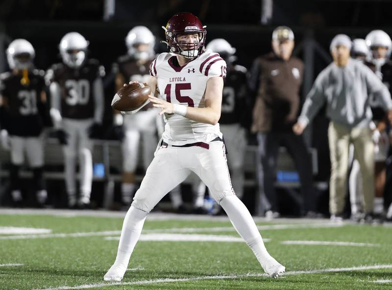 Loyola's Ryan Fitzgerald (15) looks for a receiver during the varsity football game between Loyola Academy and Mt. Carmel high school on Friday, Oct. 25, 2024 in Chicago.