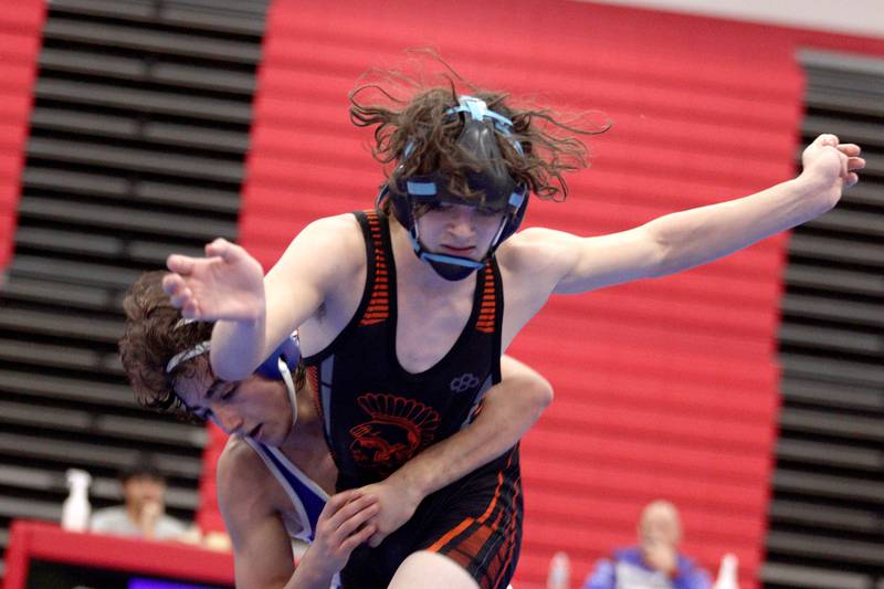 McHenry’s Zach Ference, front, battles Dundee-Crown’s Vinnie Velazquez in a 132-pound bout in varsity wrestling at Carpentersville Thursday night.