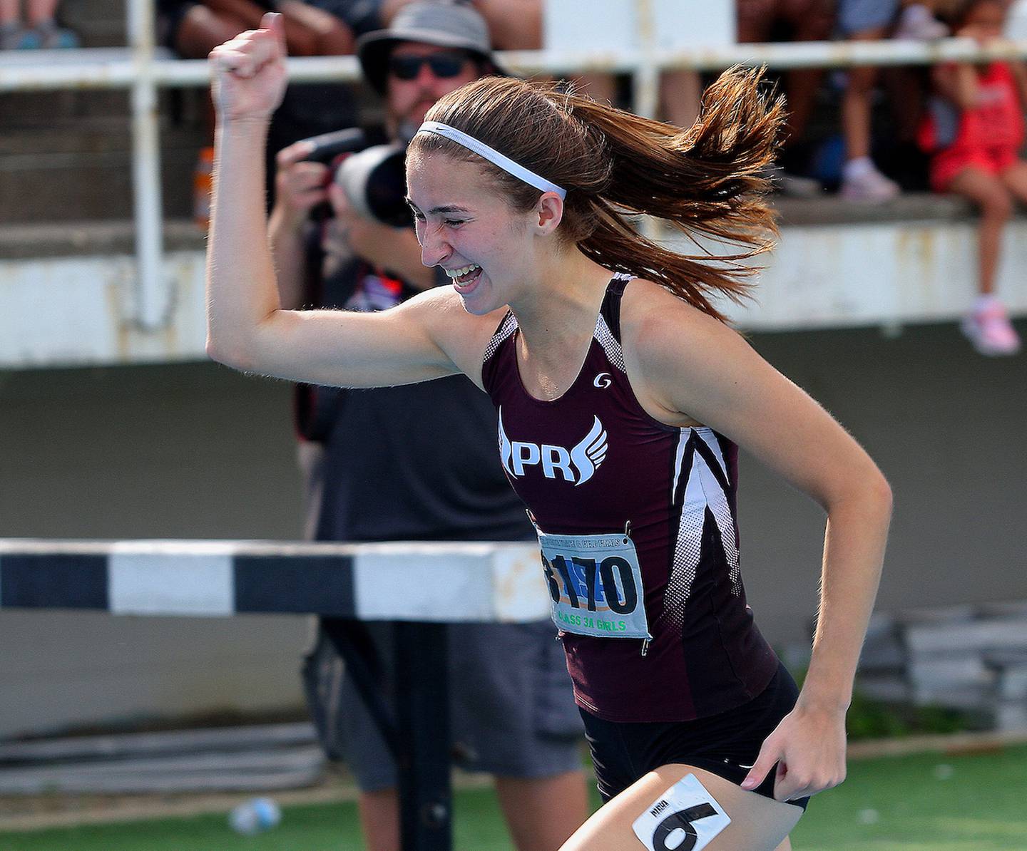 Prairie Ridge's Rylee Lydon celebrates as she crosses the finish line in the Class 3A 400-meter dash June 12, 2021 at the IHSA Track & Field State Finals.