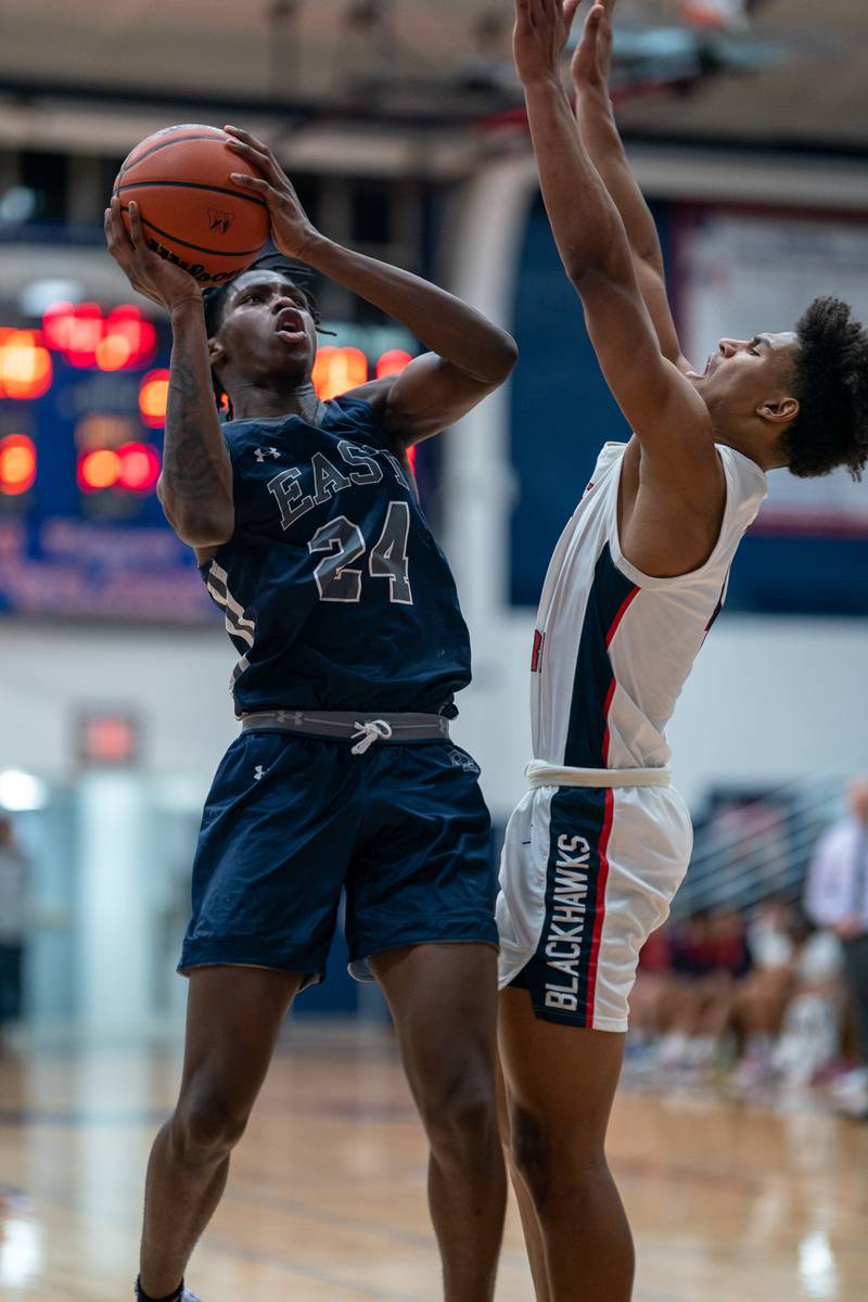 Oswego East's Mekhi Lowery (24) shoots the ball in the post against West Aurora's Joshua Pickett (4) during a basketball game at West Aurora High School on Friday, Jan 27, 2023.