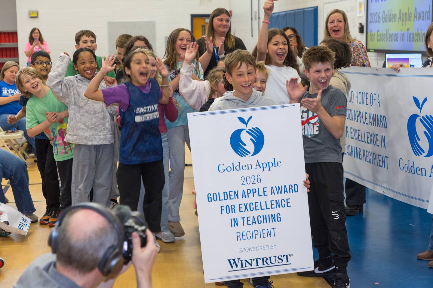 Students show their excitement as the Golden Apple Foundation on May 7 surprised Kristina Lancaster, a fourth-grade teacher at Big Hollow Elementary School in Ingleside, with the prestigious Golden Apple Award for Excellence in Teaching.