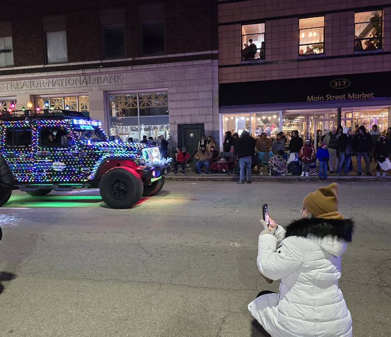 Parade goers take photos of their favorite participants Saturday, Nov. 30, 2024, during the Lighted Christmas Parade in Streator.