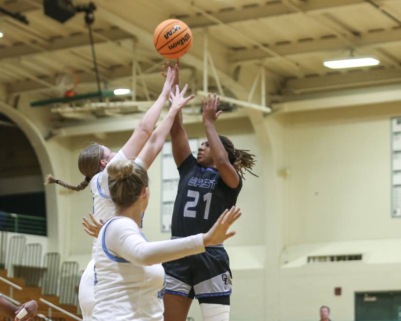 Oswego East's Desiree Merritt (21) puts up a shot over the defense during their York Thanksgiving Tournament matchup between Oswego East at Downers Grove South Friday, Nov 20, 2025 in Elmhurst.