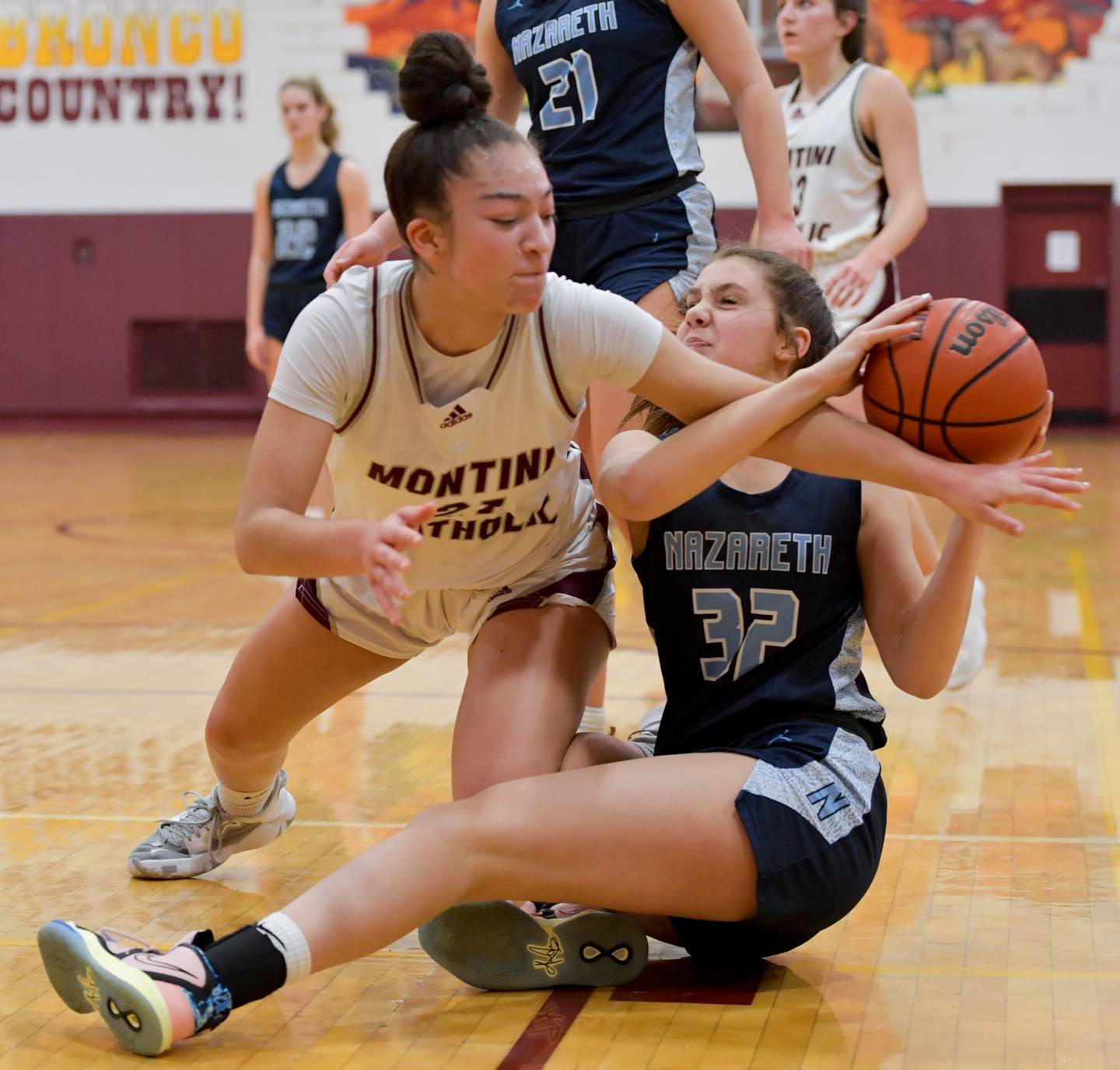 Montini's Alyssa Epps (21) and Nazareth's Stella Sakalas (32) struggle for control of the ball during the 2nd quarter of the semifinals at the Montini Catholic Christmas Tournament on Thursday, December 29, 2022.