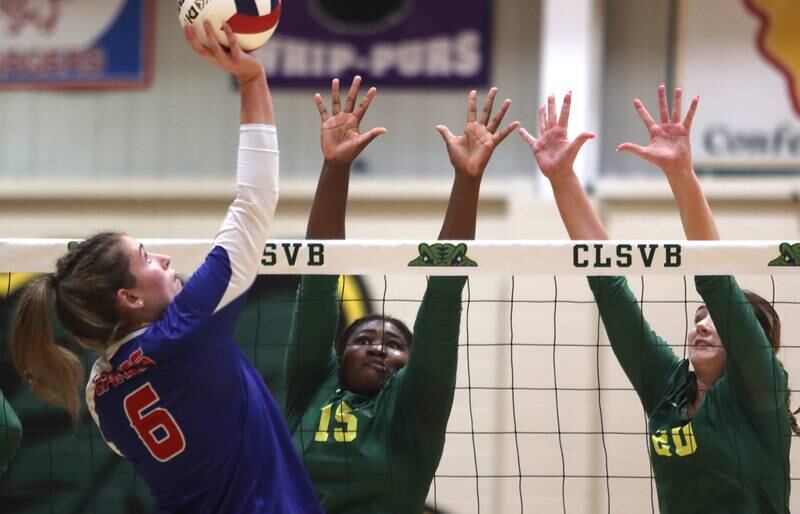 Lakes’ Riley Bell-Nance, left, hits the ball as Crystal Lake South’s Sahara Okirika, center, and Morgan Johnson block in IHSA Class 3A Sectional semifinal volleyball action on Tuesday, Nov. 5, 2024, at  Crystal Lake South High School  in Crystal Lake.