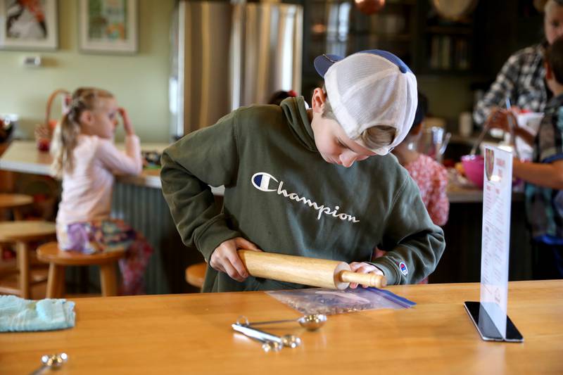 The Learning Door student Jake Fett, 11, of Wayne crushes pecans for a recipe during a Fun Friday at the Farmhouse School in Campton Hills.