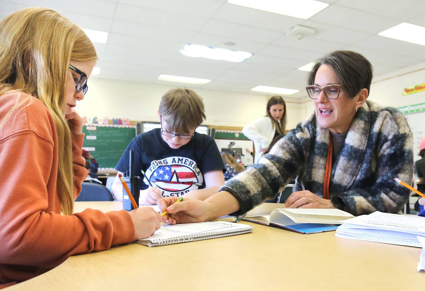 Mary Lynn Buckner, longtime educator at Littlejohn Elementary School, supports Nicole Schmidt's fifth-grade class during their individual work time Tuesday, March 14, 2023, at the school in DeKalb.