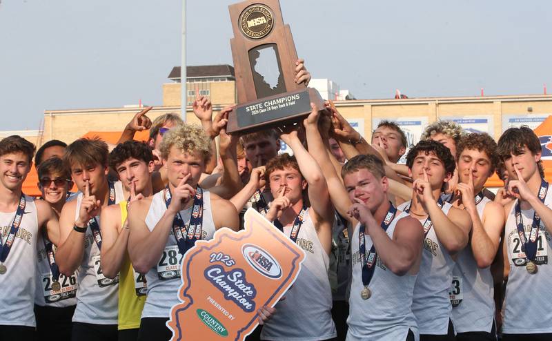 Members of the Sycamore boys  track team hoist the Class 2A first place trophy during the IHSA Class 1A Boys Track & Field State Finals on Saturday, May 31, 2025 at Eastern Illinois University in Charleston.