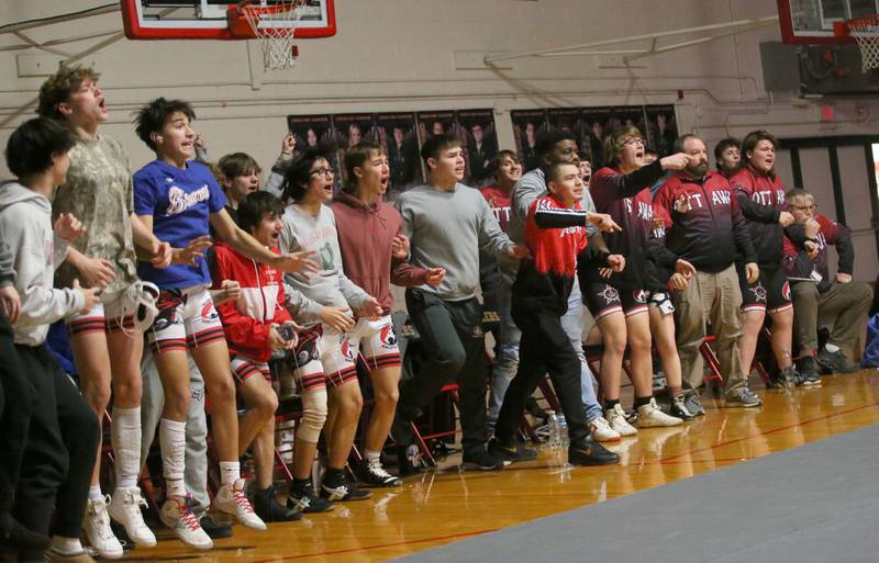 Members of the Ottawa wrestling team reacts while cheering on teammate Kaden Geiger on Thursday, Jan. 9, 2025 in Sellett Gymnasium at L-P High School.