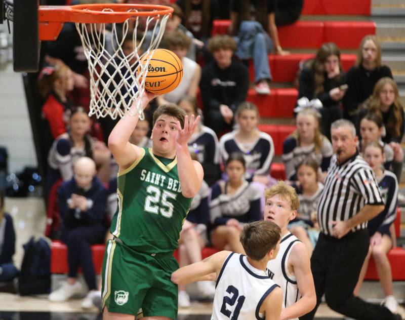 St. Bede's Jake Miglorini runs in for a layup over Ridgeview's Tanner Maupin and Carter Beck during the Route 17 Classic Tournament on Wednesday, Nov. 27, 2024 at Woodland High School.