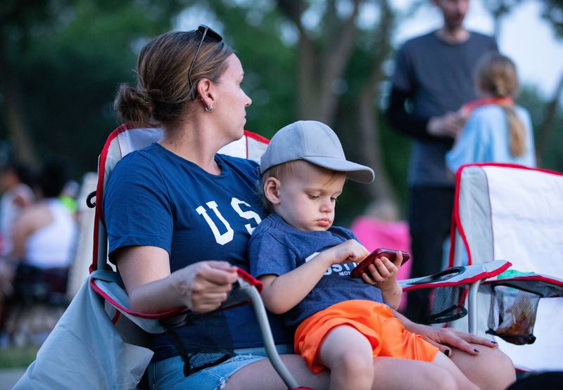 Danica and Brent, 2, Vandenheuvel wait for the fireworks to begin during North Aurora's annual Independence Day celebration at Riverfront Park in North Aurora on Monday, July 3, 2023.