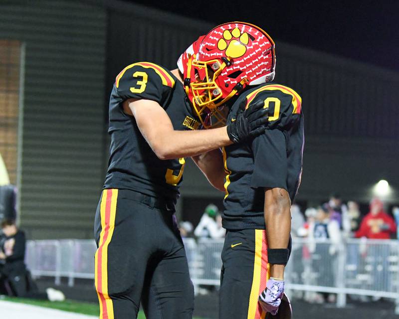 Batavia's Nick Jansey (9) gets congratulated by teammate Thomas Prescott (3) after scoring a touchdown against Hoffman Estate in the first round of playoffs held at Batavia High School.