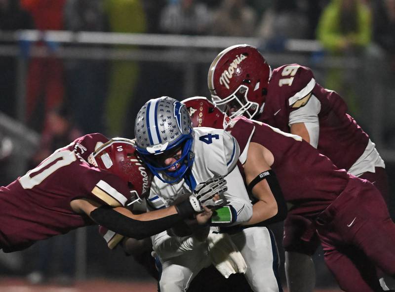 Woodstock's Caden Thompson (4) gets gang tackled during the class 4A first round playoff game against Morris' on Friday, OCT. 31, 2025, at Morris.