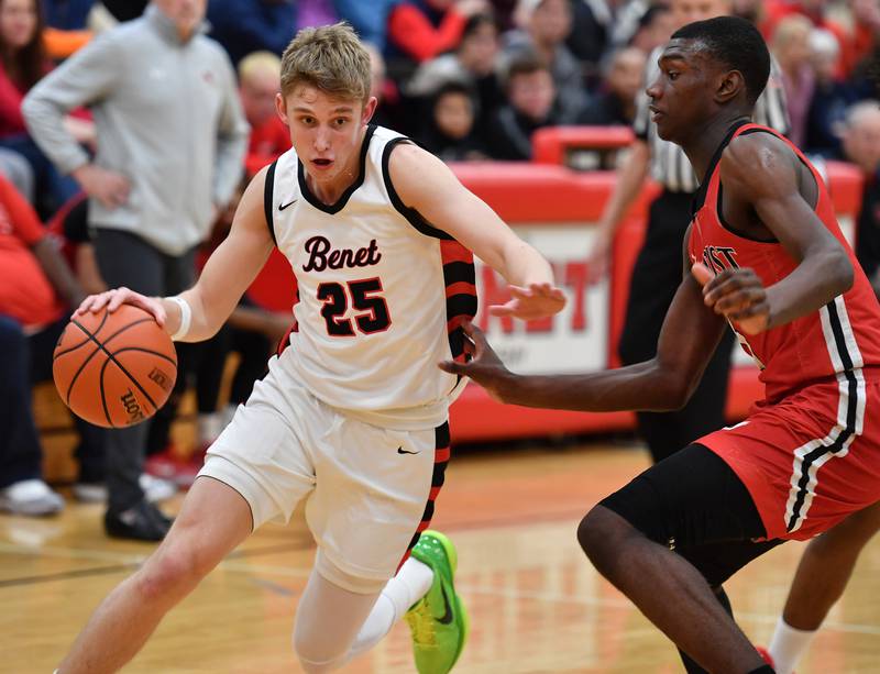 Benet's Gabe Sularski (25) drives past Marist's Stephen Brown during a game on Dec. 15, 2023 at Benet Academy in Lisle.