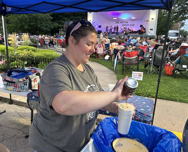 Tiffany West of the Let Freedom Ring Committee serves up a root beer float during the Jamboree Concert Series in Mt. Morris on Friday, July 25, 2025.