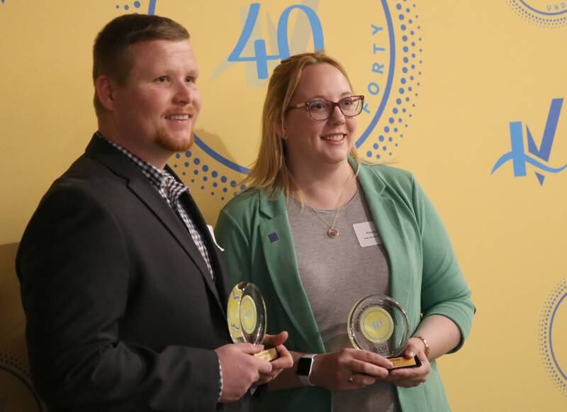Patrick Chismarick and Erin Karlosky pose for a photo with their awards during the 40 Under Forty awards banquet on Thursday, March 21, 2024 at Westclox in Peru.