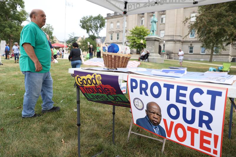Signs honoring the late civil rights leader and congressman John Lewis are displayed during a "Good Trouble Lives On" rally held in Kankakee as part of a national day of peaceful protests on Thursday, July 17, 2025.