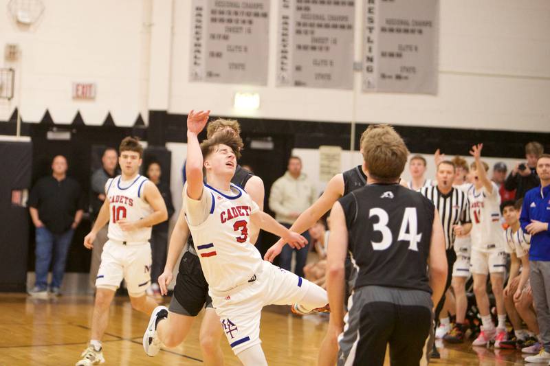 Marmion Academy's Collion Wainscott shots a half court shot at the buzzer ending the second quarter at the Class 3A Regional Final at Kaneland on Saturday, Feb.25, 2023.