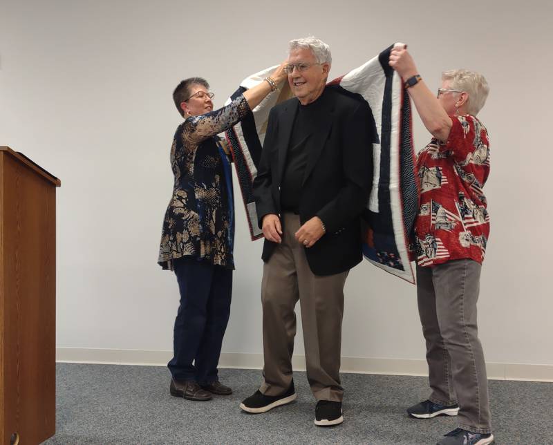 Boyd Palmer, of Ottawa, is given a Quilt of Valor by (from left) Terry Johnson and Betty Baznik on Wednesday, Nov. 8, 2023.