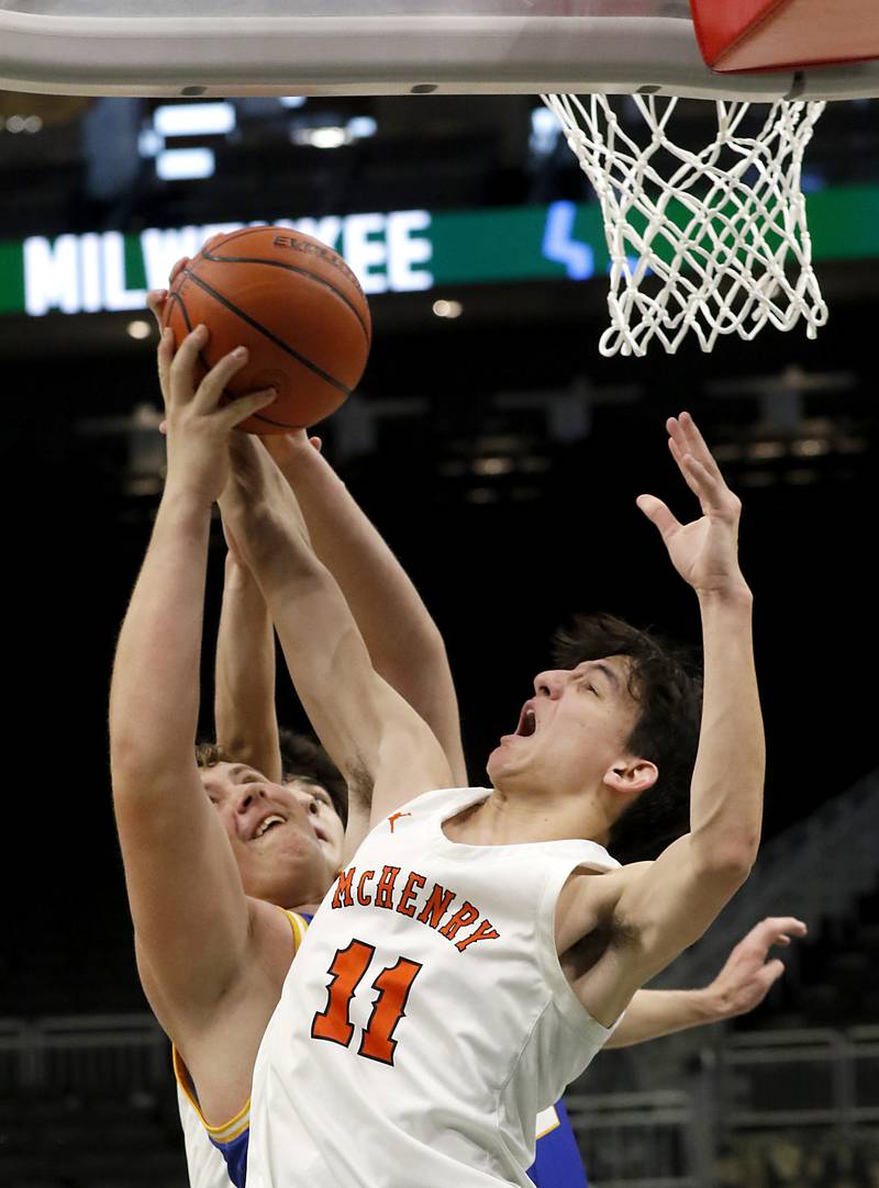 Johnsburg's Jacob Welch battles for a rebound with McHenry's Hayden Stone during a non-conference basketball game Sunday, Nov. 27, 2022, between Johnsburg and McHenry at Fiserv Forum in Milwaukee.