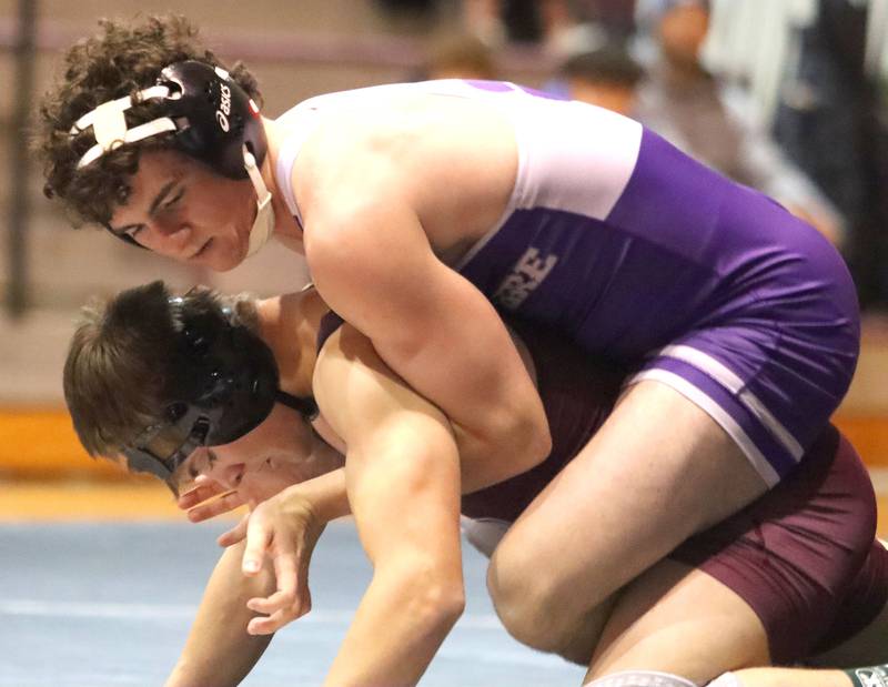 Prairie Ridge’s Caleb Harmke, bottom, battles Hampshire’s Dawson Smith at 144 pounds in varsity boys wrestling on Thursday, Dec. 4, 2025, at  Prairie Ridge High School in Crystal Lake.
