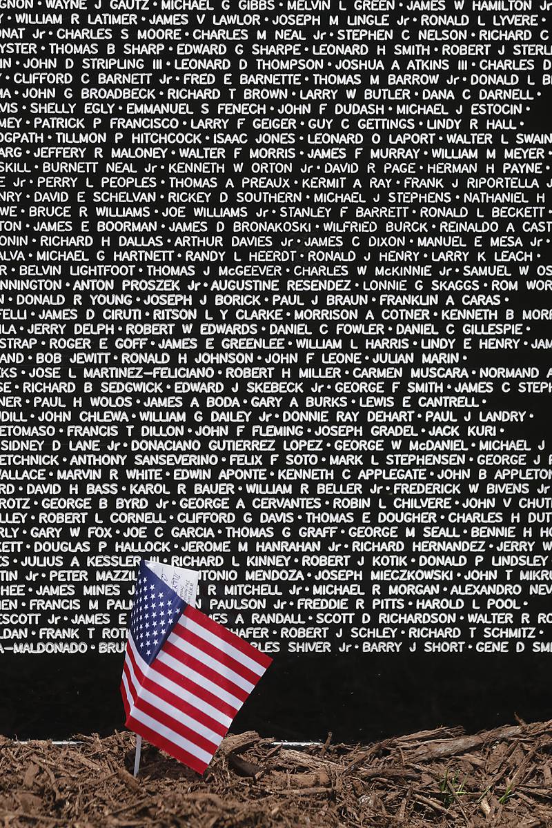 A small American Flag is left Friday, July 14, 2023, at the Vietnam Traveling Memorial Wall at the VFW Post 4600 in McHenry. The 3/5 scale wall will be at the post and open to the public until Sunday evening and will hold an opening  ceremony at 10 a.m. on Saturday.
