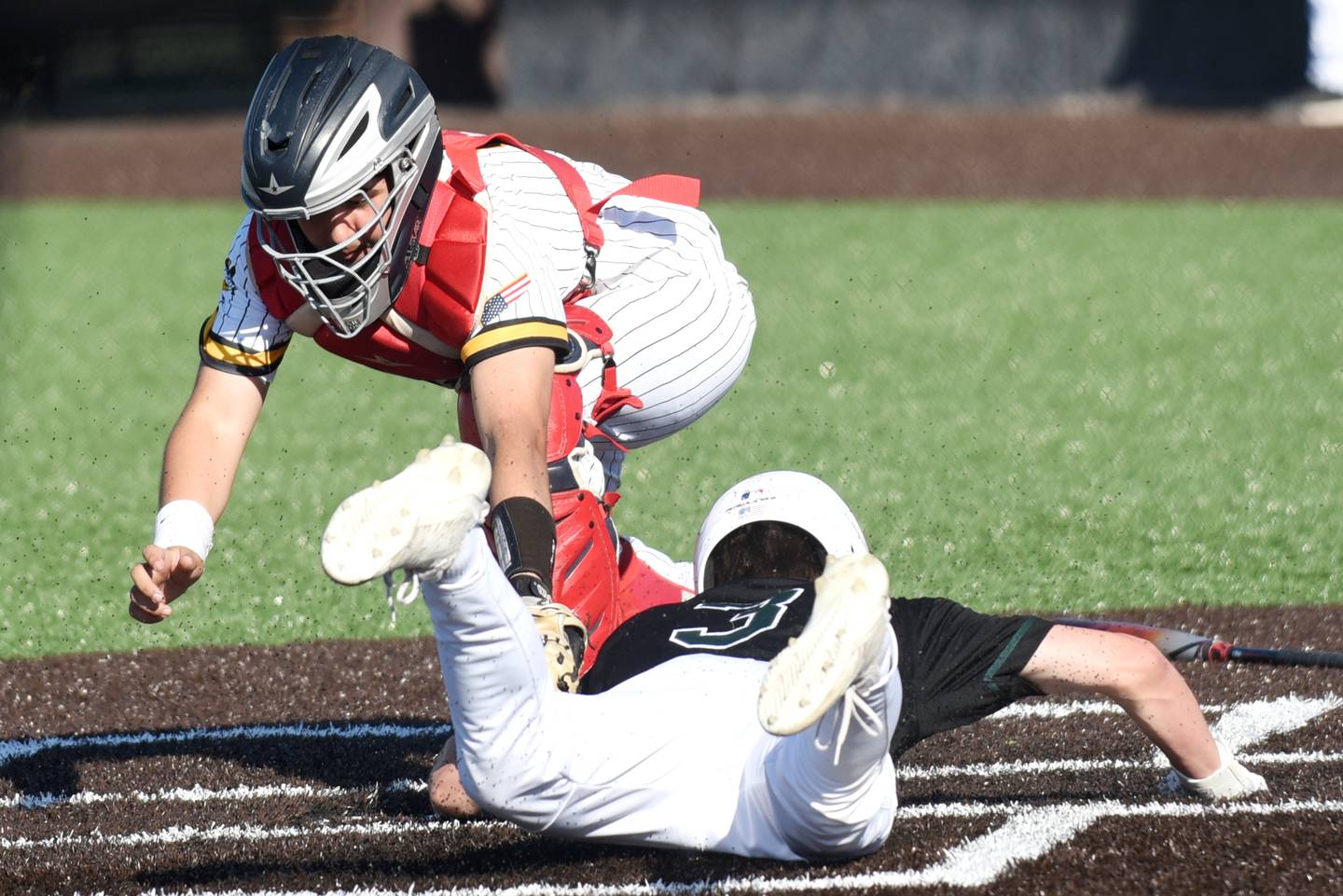 Reed-Custer's Alex Fierro, left, applies a late tag on Coal City's Lance Cuddy at home plate during a game at Reed-Custer Tuesday, May 6, 2025.