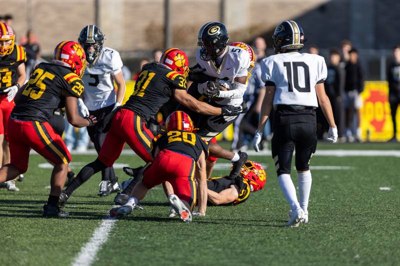 Glenbard North's William Cook Lesley is tackled by Batavia defense at the Class 7A Quarter Final on Saturday, Nov.15,2025 in Batavia.