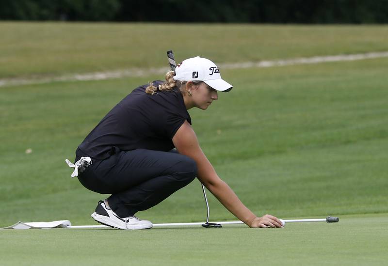 McHenry’s Madison Donovan lines up a putt on the third green during the Fox Valley Conference Girls Golf Tournament Wednesday, Sept. 20, 2023, at Crystal Woods Golf Club in Woodstock.