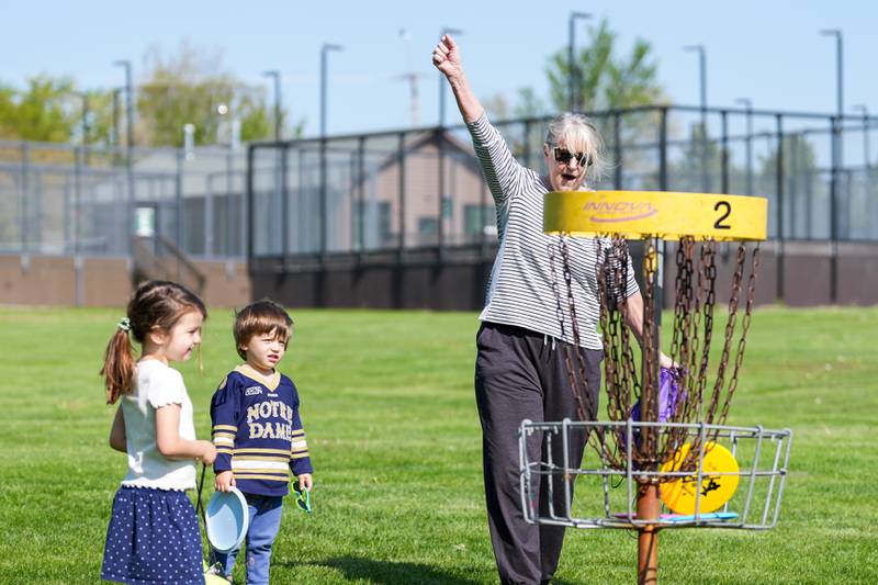 Player celebrates landing the disc into the hole during the Glen Ellyn Park District Ace Race disc golf event at Maryknoll Park in Glen Ellyn, IL on Saturday May 10th, 2025.  The Ace Race is just one of many events the Glen Ellyn Park District holds throughout the year.