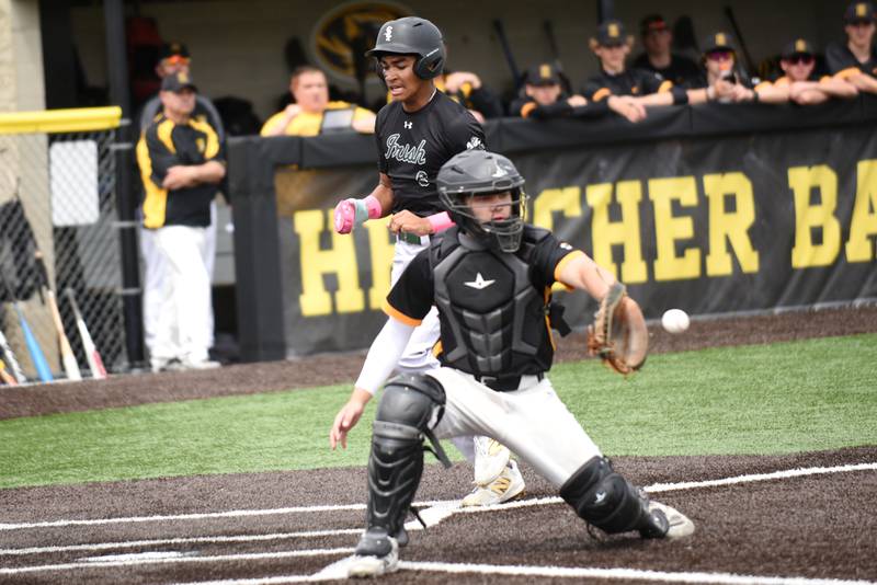 Bishop McNamara's Gavin Jones, top, scores a run as Herscher's Keegan Andre fields a throw home during the Class 2A Herscher Regional championship Saturday, May 24, 2025.