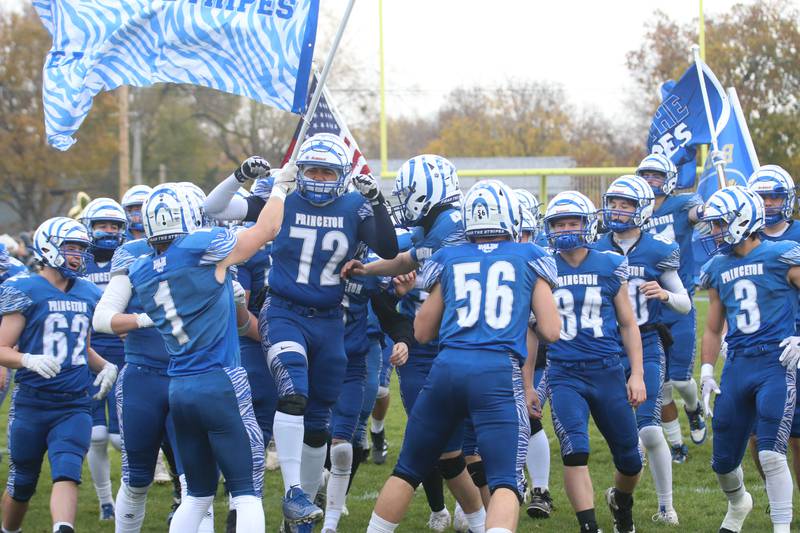 The Princeton Tigers take the field before playing Montini Catholic during the Class 3A quarterfinal game on Saturday, Nov. 16, 2024 at Bryant Field in Princeton.