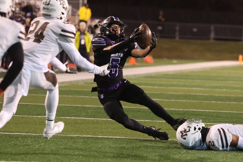 Downers Grove North’s Owen Thulin catches the deflected pass for a 1st down against Mt. Carmel in the Class 7A championship on Saturday, Nov. 25, 2023 at Hancock Stadium in Normal.