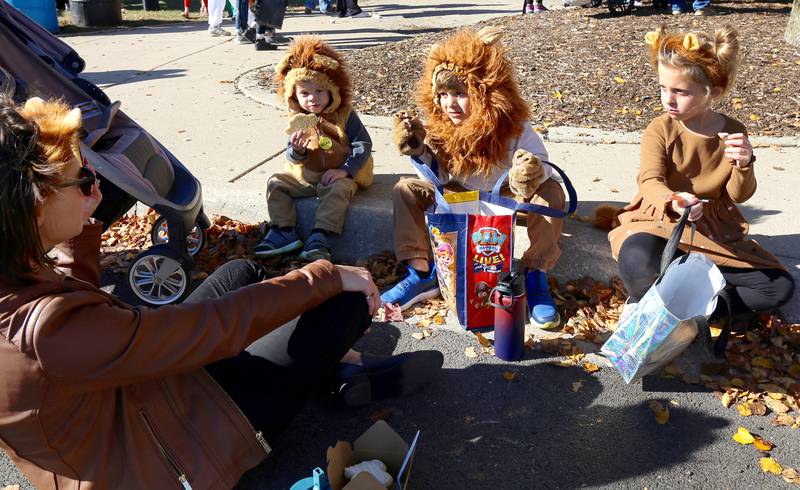 Orie, Ollie and Evie Deters have a snack with their mom Meghan at Batavia Bat Fest on Saturday, Oct. 26, 2024.