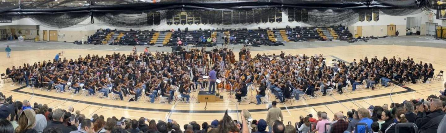 The entire Joliet Township High School orchestra playing with incoming eighth grade members from Joliet's junior high schools.